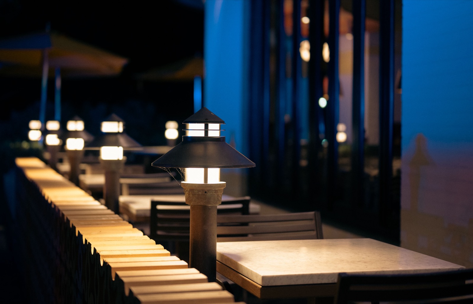 Bar terrace lit by lanterns in the evening