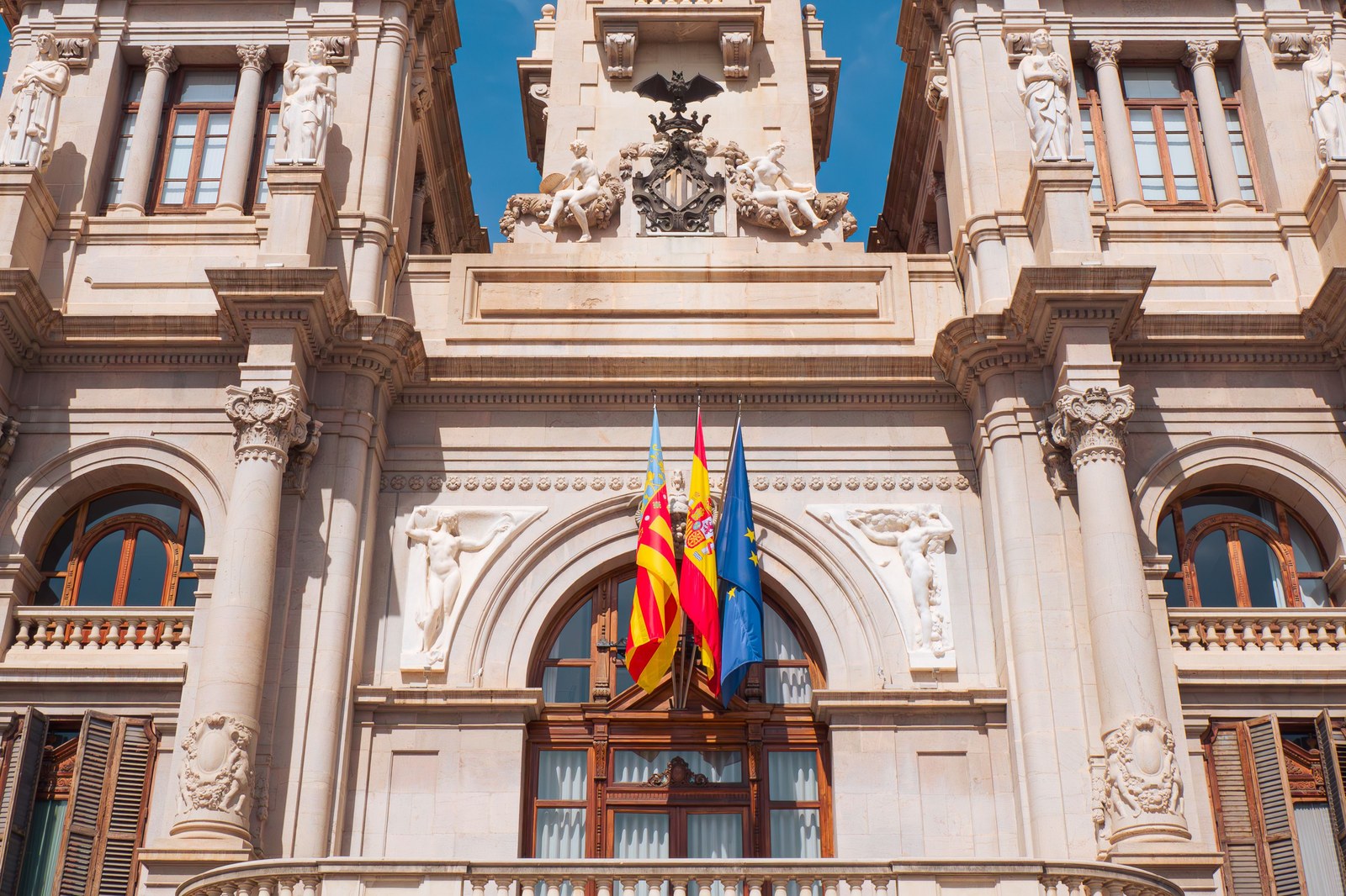 Valencia town hall facade with Spanish, Valencian, and EU flags