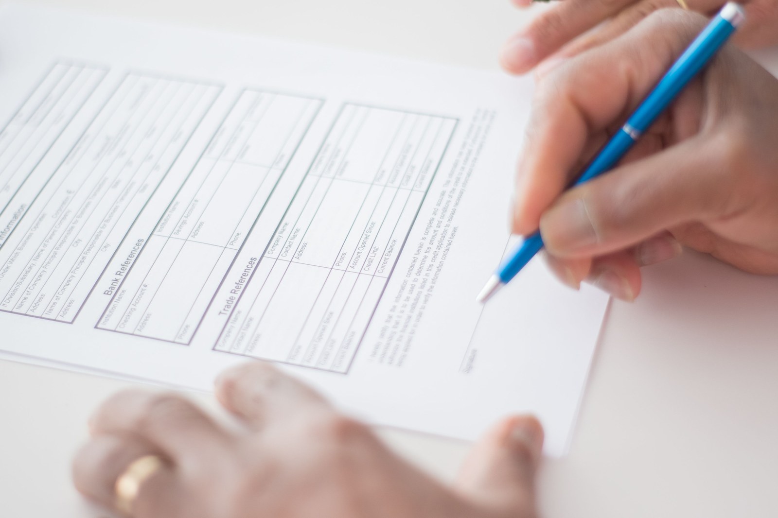 Hand signing a rental contract with a pen