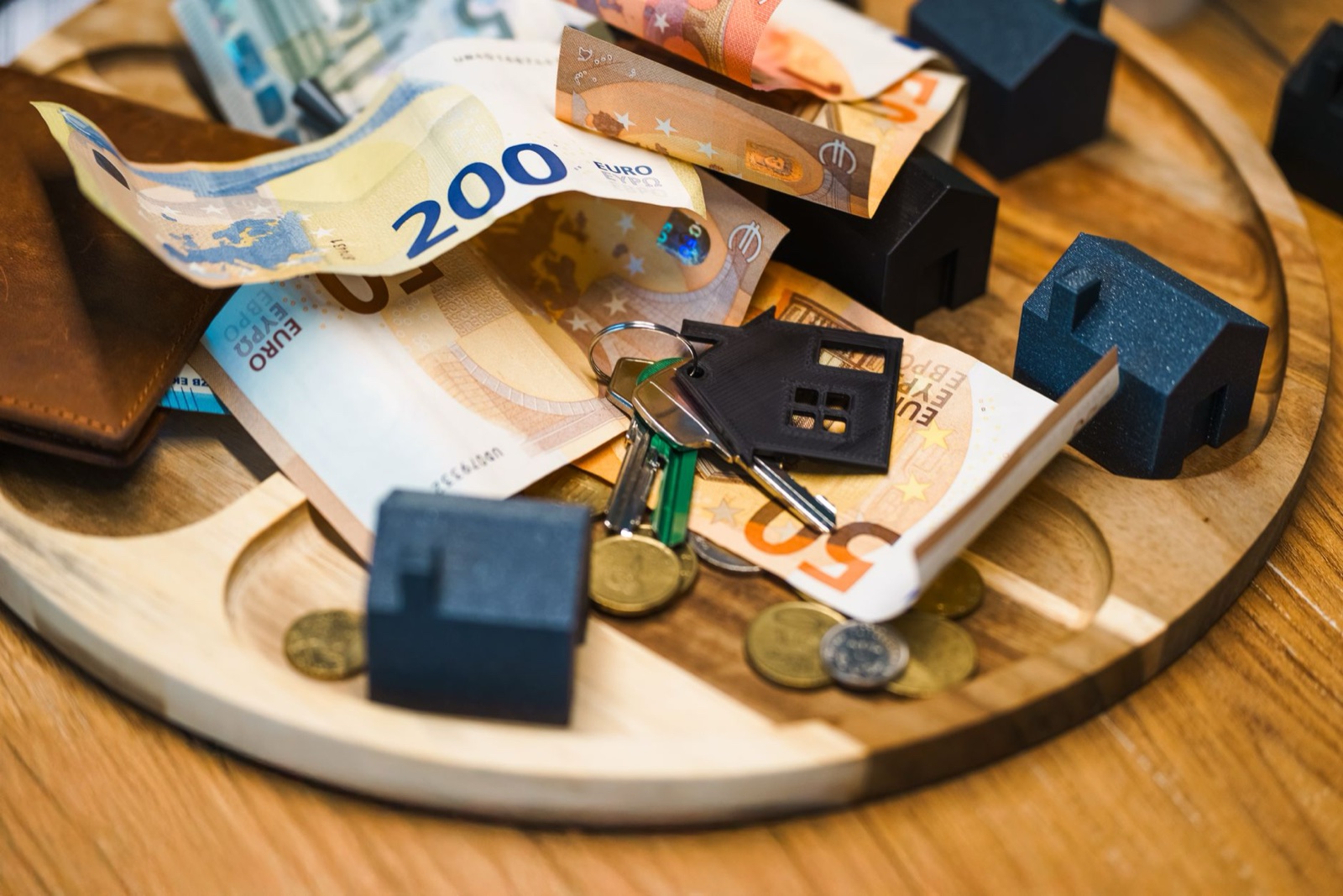 Euro banknotes, keys, and miniature houses