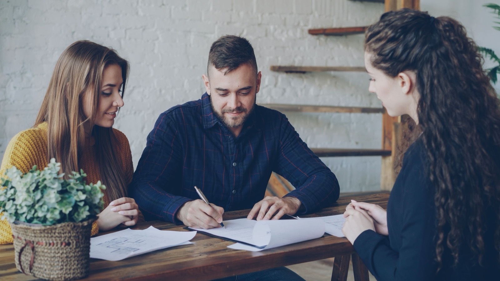 Couple signing a lease with an agent