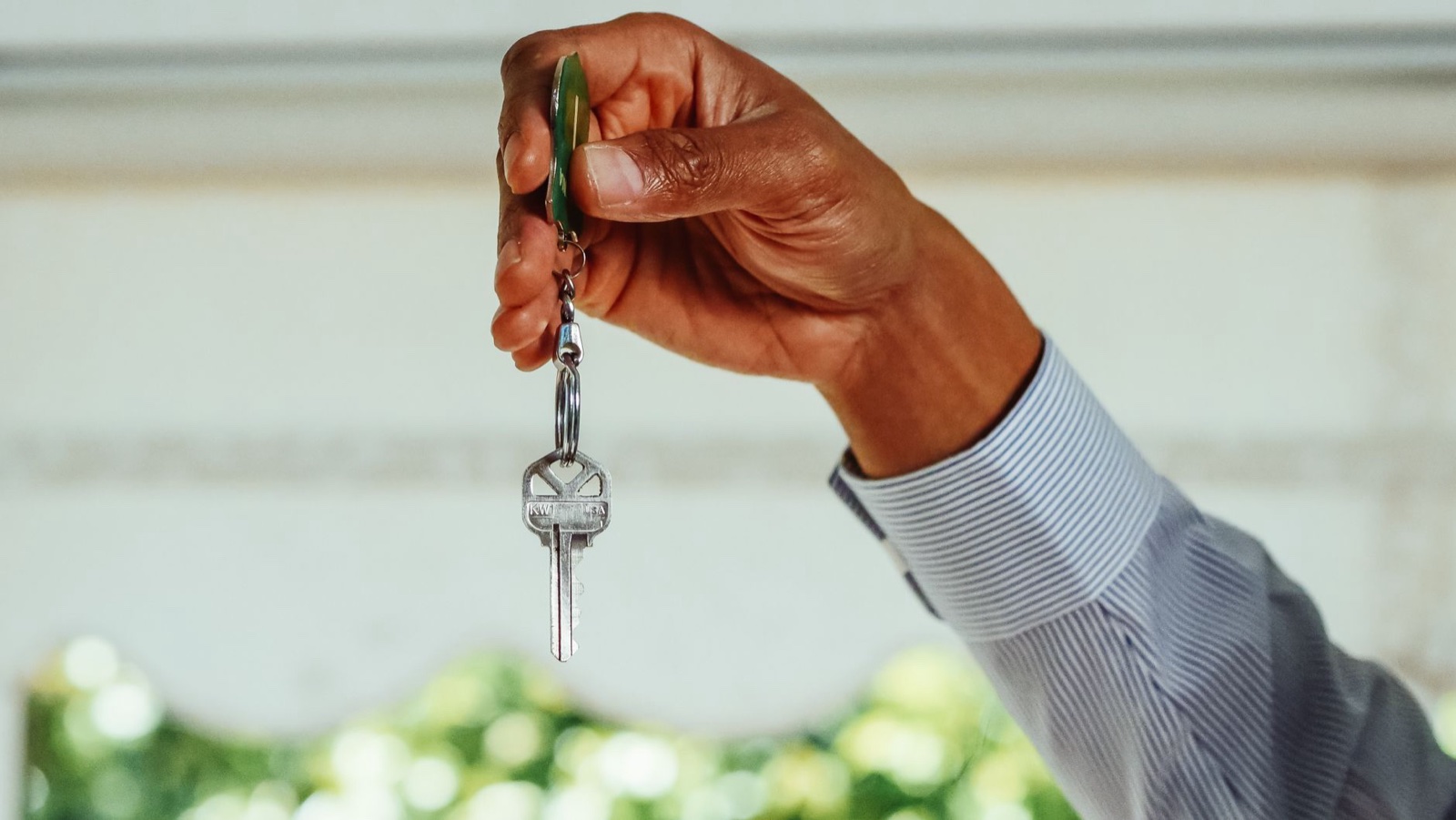 Hand holding an apartment key