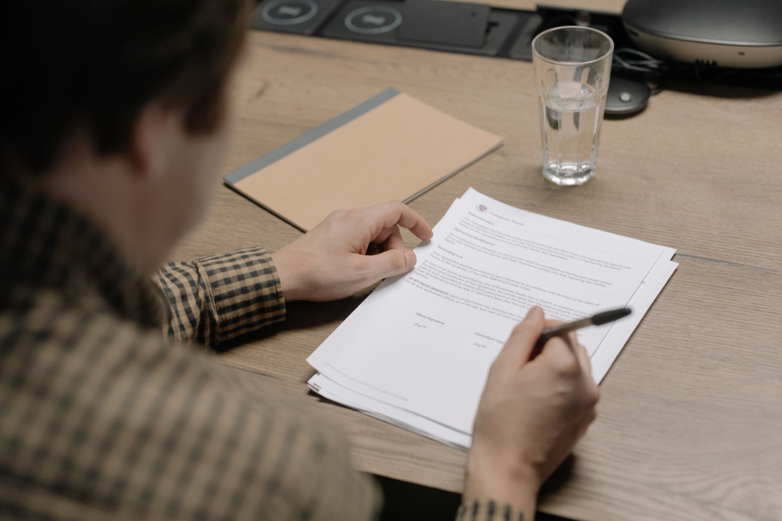 Reviewing a property document at a desk before signing